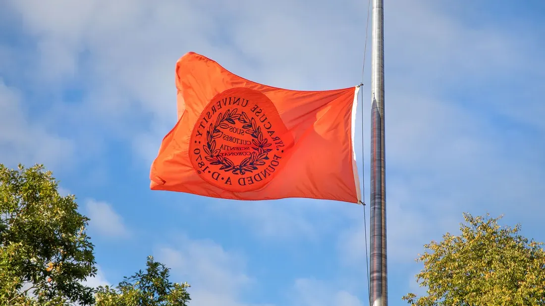 Syracuse University flag in the wind.